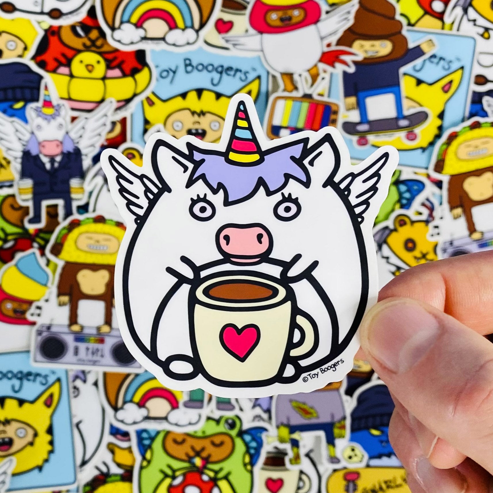 Cute sticker of a unicorn drinking a cup of coffee.