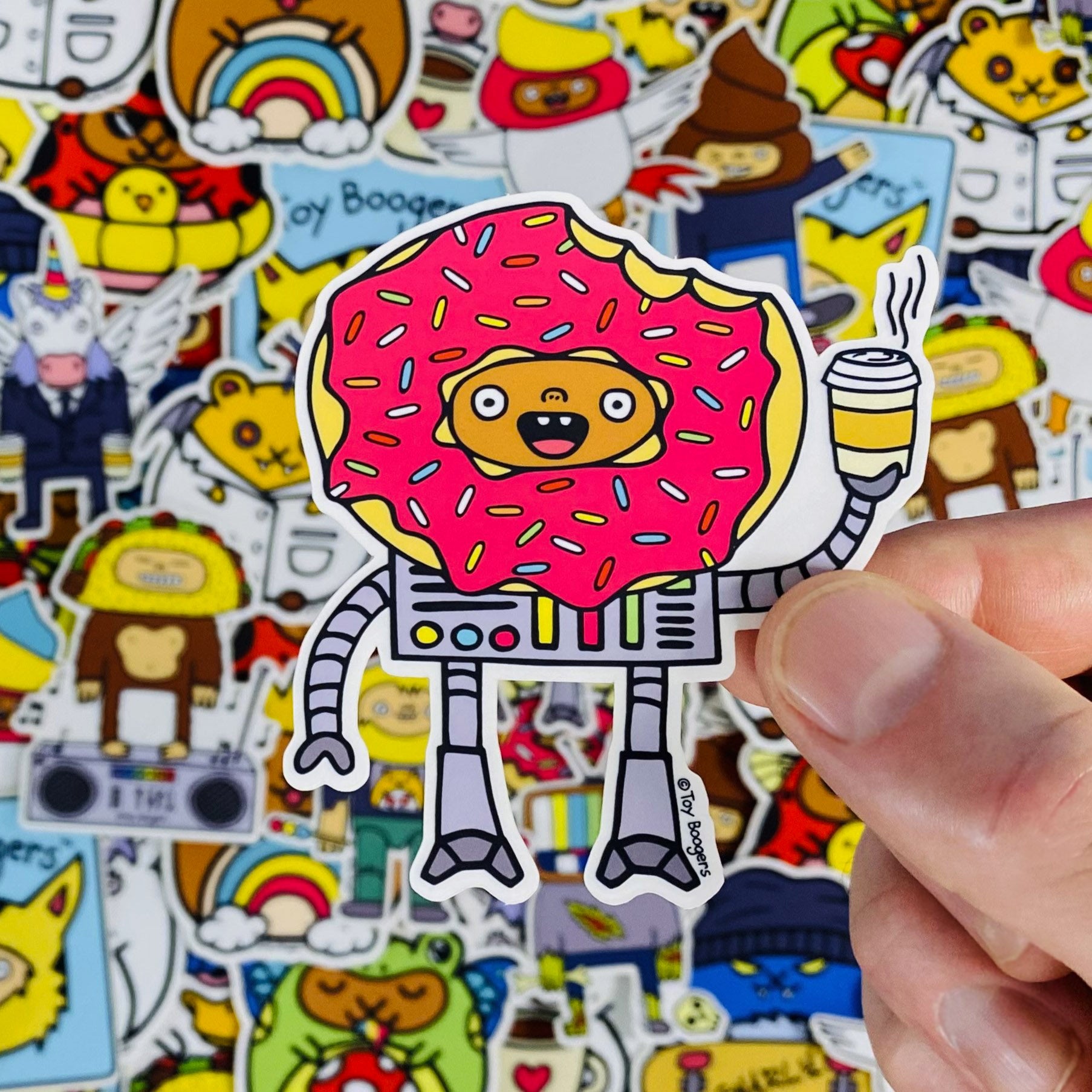 Funny sticker of a donut-headed robot holding a cup of coffee.