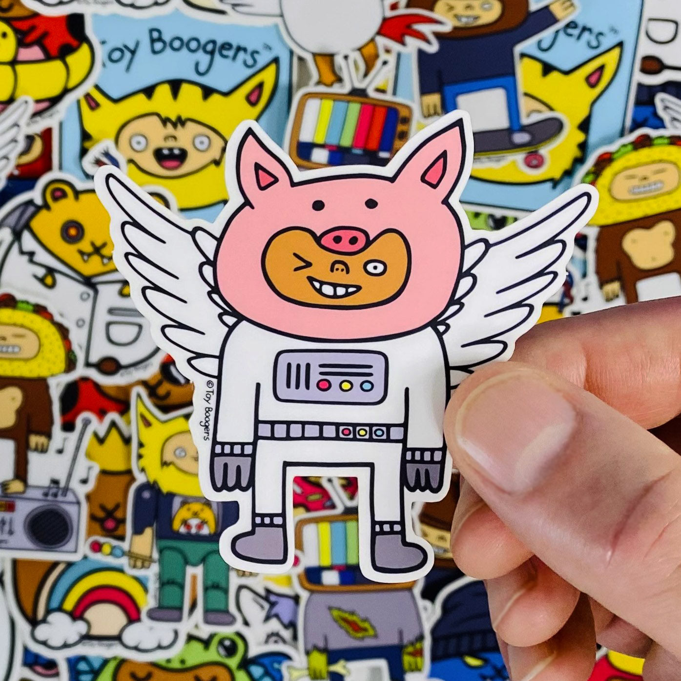 Funny sticker of a flying pig wearing a spacesuit.