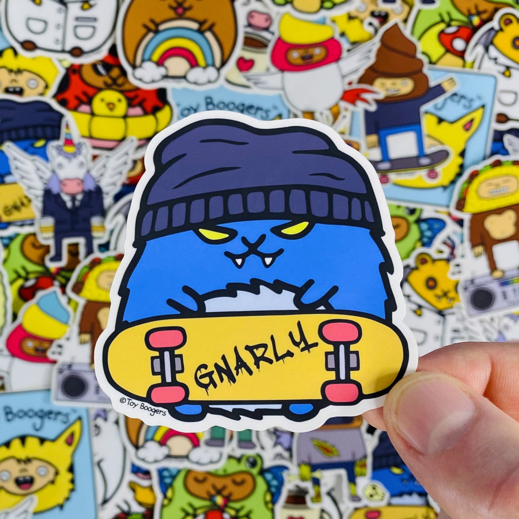 Cool sticker of a hamster with a skateboard and wearing a beanie. 