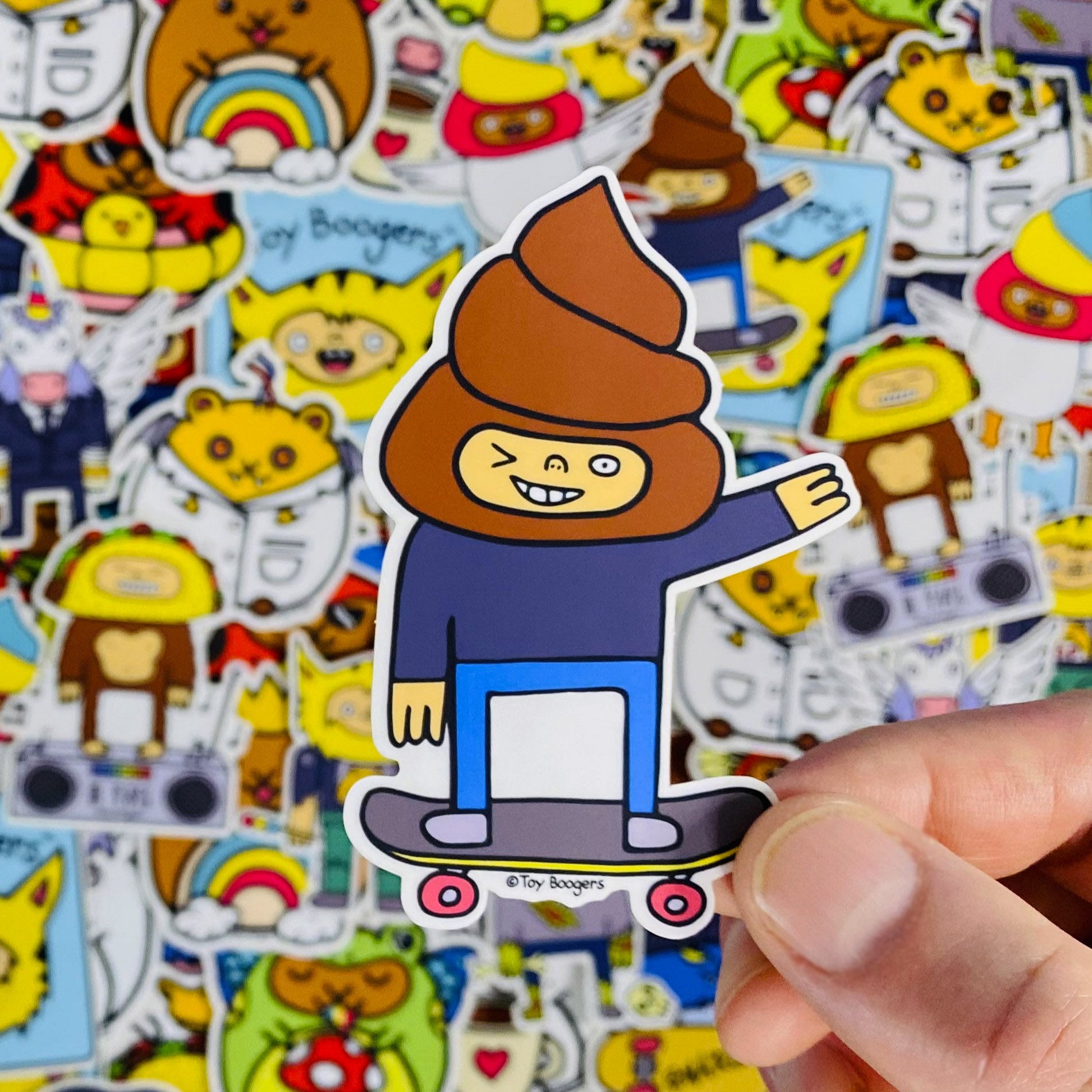 Sticker of a cartoon poop-head character on a skateboard.